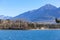 A scenics view of the Embrun, France lake with snowy mountains range in the background under a majestic blue sky