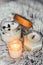 Scented candles in the interior. Interior details in milky and cold colors. Combination of warm and cold colors. Candles in a