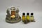 Scented lamp, Buda figures, candle, bottle of scented oil close-up. Bottles of oil.