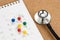 Schedule or appointment to meet the doctor for medical and health check up concept, stethoscope with colorful thumbtack or pushpin