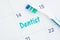 Schedule a dentist appointment message on a calendar with a toothbrush