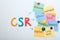 Scheme with abbreviation CSR and its components written on magnetic whiteboard. Corporate social responsibility