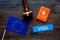 Schengen visa. Visa to Europe concept. Text visa near passport cover and european flag, judge hammer on dark wooden