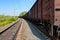 SCHERBINKA, MOSCOW, JULY, 19, 2007: Perspective view on railway freight train brown gondola freight cars wheel sets axle