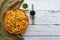 Schezwan Noodles with vegetables in a plate on a wooden table. Top view. Hakka Noodles is a popular Indo-Chinese recipes.