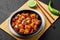 Schezwan Paneer in black bowl at dark slate background. Schezwan Paneer is indo-chinese cuisine dish