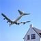 Schiphol runway approach by plane low over houses