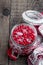 Schisandra chinensis with sugar in a glass jar on wooden table