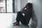 Schizophrenia with lonely and sad in mental health depression concept. Depressed woman sitting against wall at home with a shadow