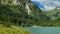 Schlierersee, Lungau Austria.Mountain peak and green transparent water of mountain lake on blue sky with clouds