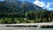 Schlierersee, Lungau Austria.Wooden chapel in pine trees on the shore of a mountain lake.Transparent green water of lake