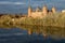 Schloss Johannisburg on the shore of the river Main with reflection, glowing in the autumn evening sun, famous historic city