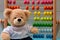 School abacus with colorful beads and cute teddy. Kids learning count  children math class concept