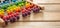 School abacus with colorful beads on wooden desk, close up view