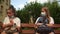 School-age children two girls in medical masks sit on a bench. The girl took off her mask and is breathing heavily