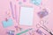 School background with notebooks and pastel colorful study accessories on pink background Back to school concept