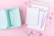 School background with notebooks and pastel colorful study accessories on pink background Empty lunch box