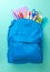 School bag. Backpack with supplies for school on blue background. Copy space for text