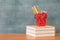 School books on desk, Back to school supplies. Books and blackboard on wooden background, education concept