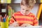 School boy at classroom desk making schoolwork