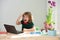 School boy doing homework. Amazed little boy learns with laptop in study room.