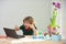 School boy doing homework. Excited little boy learns with laptop in study room.