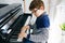 School boy with glasses playing piano in living room. Child having fun with learning to play music instrument. Talented