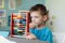 School boy learning maths with an abacus