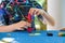 School boy playing board game with colorful bricks. Happy child build tower of wooden blocks, developing fine motor