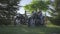 School boy playing with old motorcycle outside. Child pretends to ride a motorcycle. Antiquated vehicle in the park.