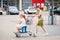 A School Boy Pushes the Cart While a Preschool Girl Happily Sits Inside, as They Enjoy a Fun Family Shopping Trip. Happy