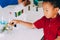 School boy use magnifier to test plant for scientific proof in science class - biology concept