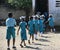 School boys and girls hurry back to class in Robillard, Haiti.