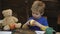 School break. Hungry kid eating apple in classroom. Little boy at desk in front of chalkboard eating apple. Schoolboy