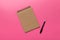 school brown notebook on a colored background, spiral craft notepad on a table Top view