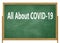 A school chalkboard blackboard with the words all about covid-19