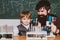 School chemistry lessons. Elementary school kid and teacher in classroom at school. Chemistry the Science Classroom. Man