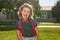School child concept. Cute pupil, kid in school uniform with backpack outdoor. Portrait of nerd schoolboy.
