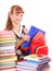 School child holding stack of books.