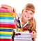 School child holding stack of books.