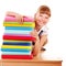 School child holding stack of books.