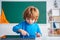 School child with tablet in school classroom. Pupil in class using digital tablet. Portrait of Pupil of primary school