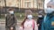 School children cross the road in medical masks. Children go to school