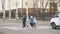 School children cross the road in medical masks. Children go to school