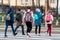 School children cross the road in medical masks. Children go to school.