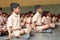 School children doing yoga with the teachers