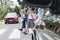 School children goes through the pedestrian crossing in the street, right in front of the car