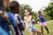 School children playing tug of war with rope