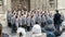 School choir singing Christmas carols in front of Bath Abbey C