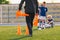 School coach preparing field for soccer training